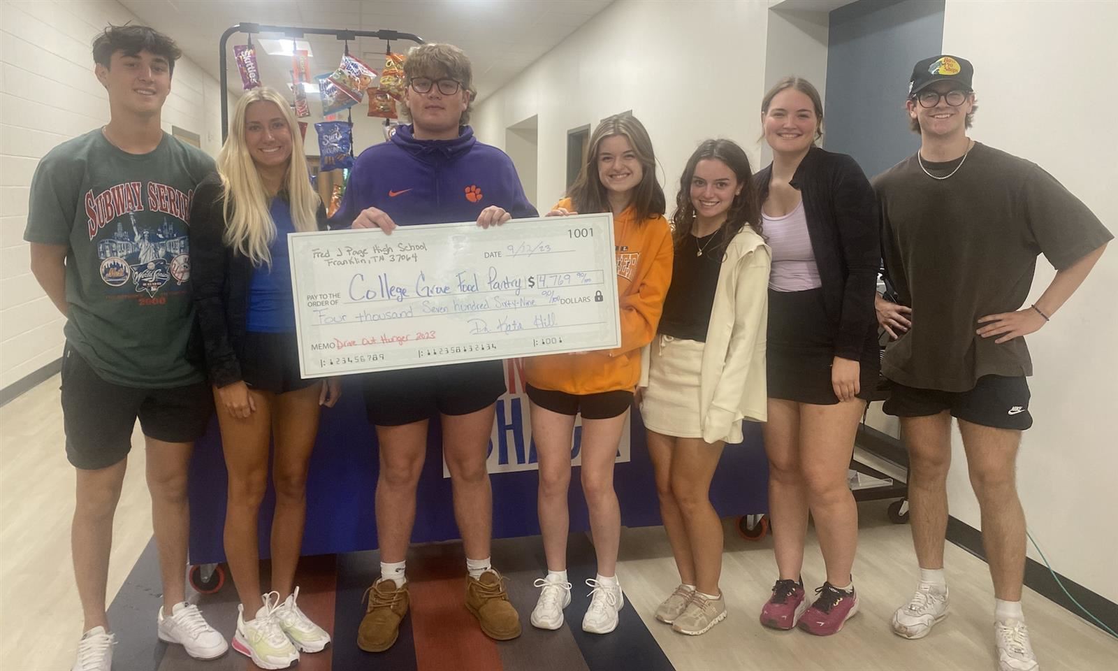  Students with oversized check